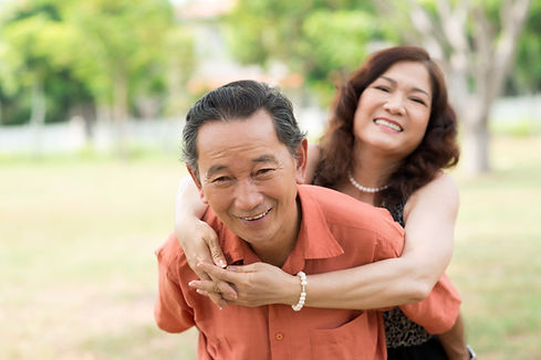 Asian husband piggyback his wife