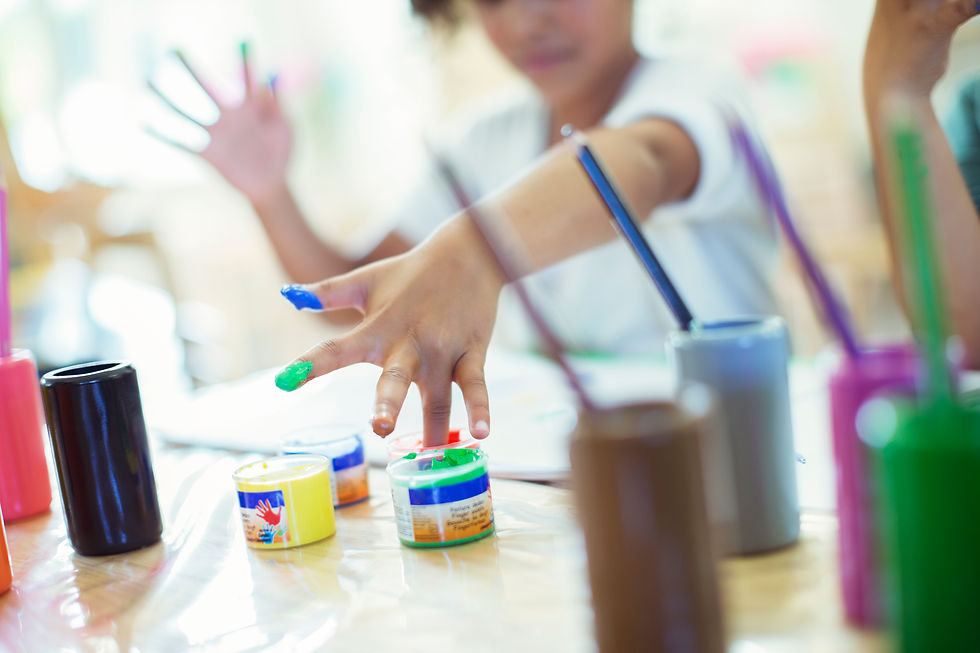 Student finger painting in class