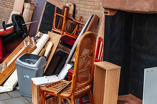 Old furniture and waste piled up outside house