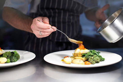 Chef plating a restaurant quality main course