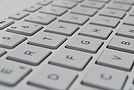 Computer Keyboard ready to assist clients with corporate, trust, and financial service inquiries at The Axebridge Group.