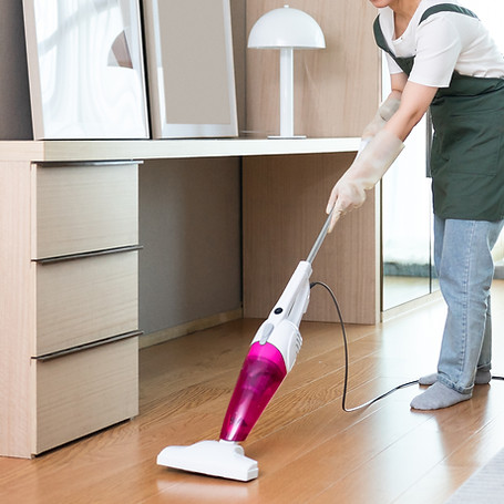 Person vacuuming wooden floor