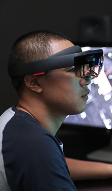 Man playing virtual reality with Microsoft HoloLens