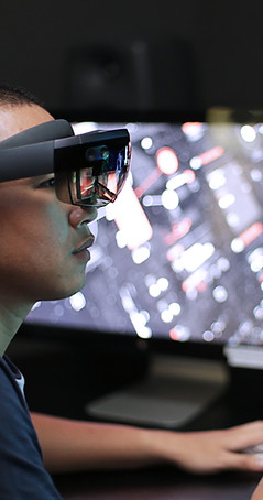 Man playing virtual reality with Microsoft HoloLens