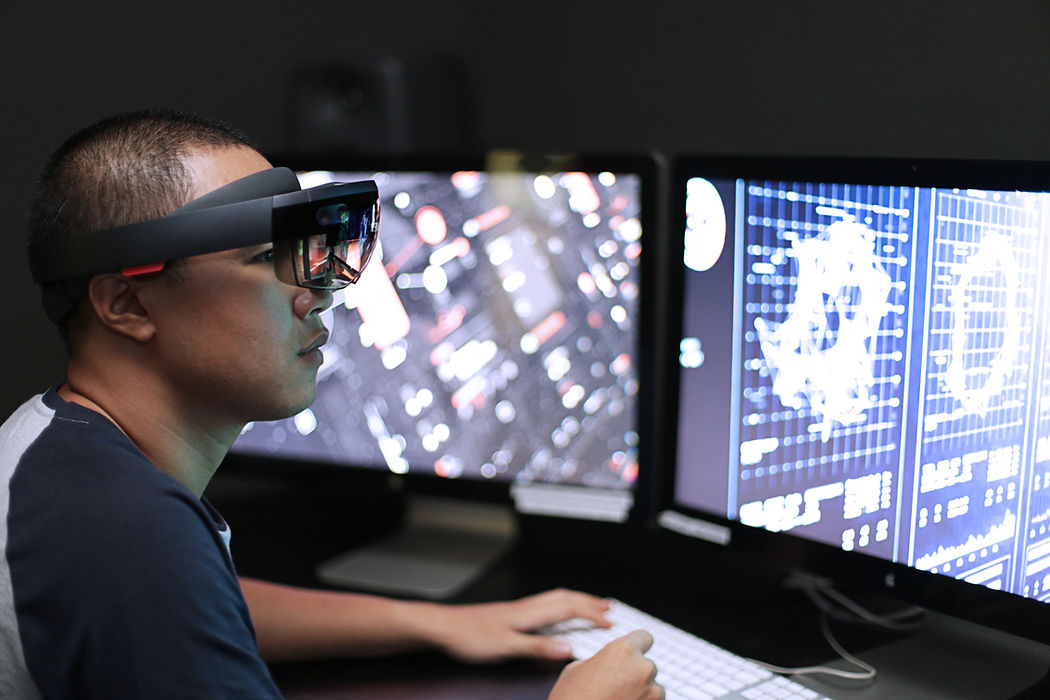 Man playing virtual reality with Microsoft HoloLens