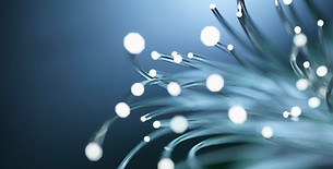 Fibre optic cables glowing with light data transmission