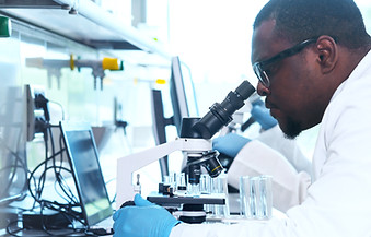 Scientist using microscope
