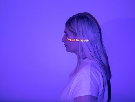 Mujer con fondo morado con un texto que dice "Proud to be me"