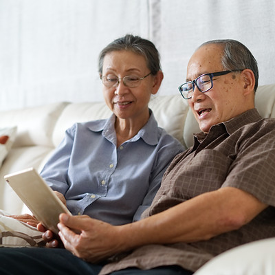 Old man and woman watching tablet