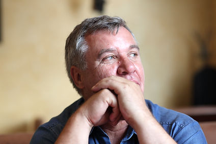 Middle-aged man in contemplation, right fist on chin, left hand supporting, reflecting on symptoms: Unexplained weight gain, decreased sex drive, mood changes, fatigue, brain fog, poor concentration, muscle loss, decreased strength, compromised immunity, and insulin resistance
