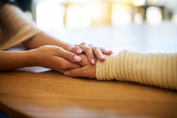 Holding hands to show compassionate and sensitive palliative care support