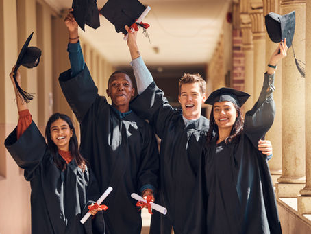 High school graduates toss caps in the air during commencement ceremony, symbolizing transition into college, careers, and civic readiness.