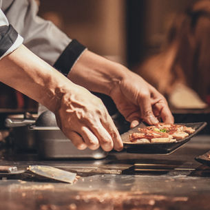 Koch bereitet Speisen im Hauptgang zu