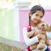 child hugging bear