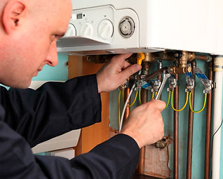 Plumber installing a boiler, close up shot of his hands