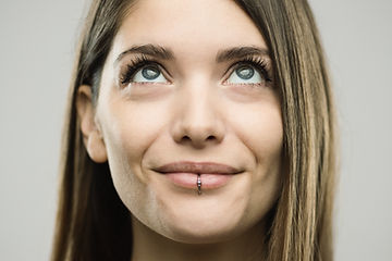 Close-up portrait of confident beautiful young woman with happy and curious expression. Re