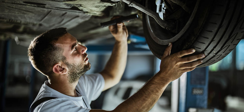 Auto mechanic analysing a car