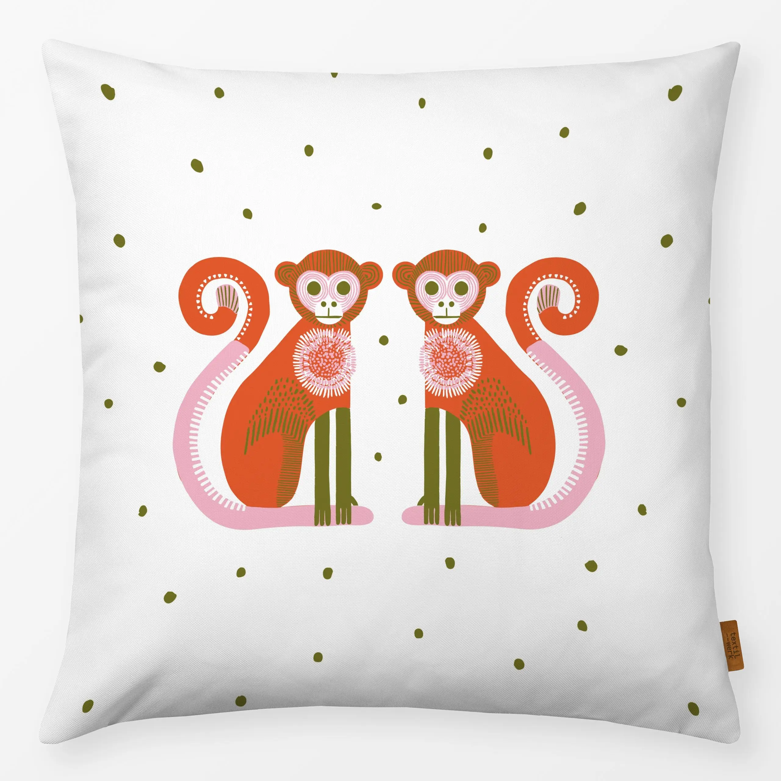White cushion with two playful monkey illustrations and olive green dots by moDeern for Textilwerk