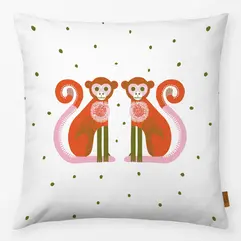 White cushion with two playful monkey illustrations and olive green dots by moDeern for Textilwerk