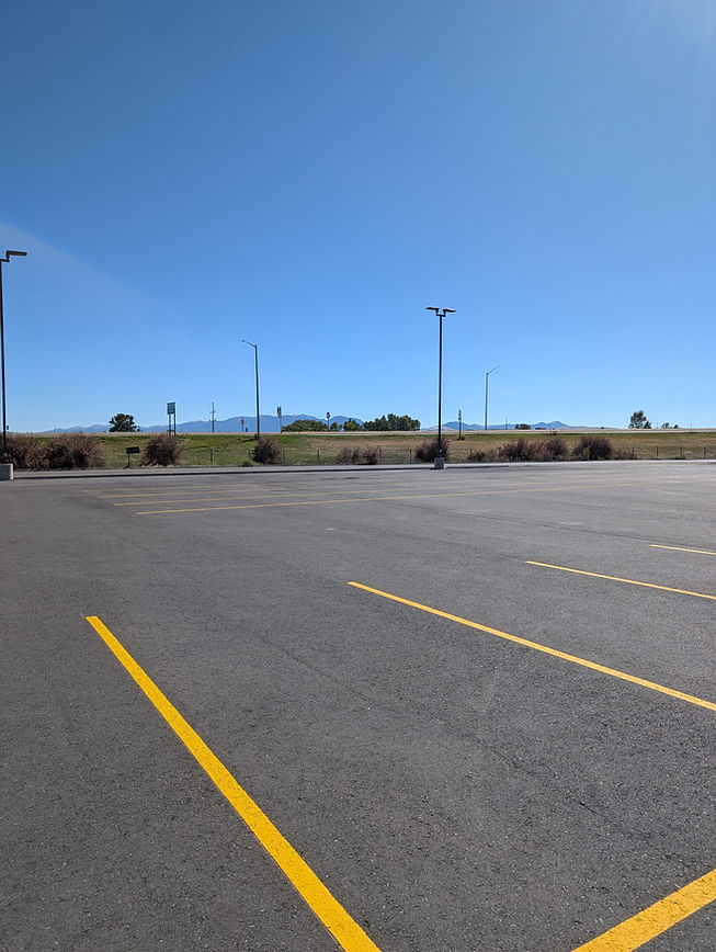 yellow parking lot stripes on fresh asphalt
