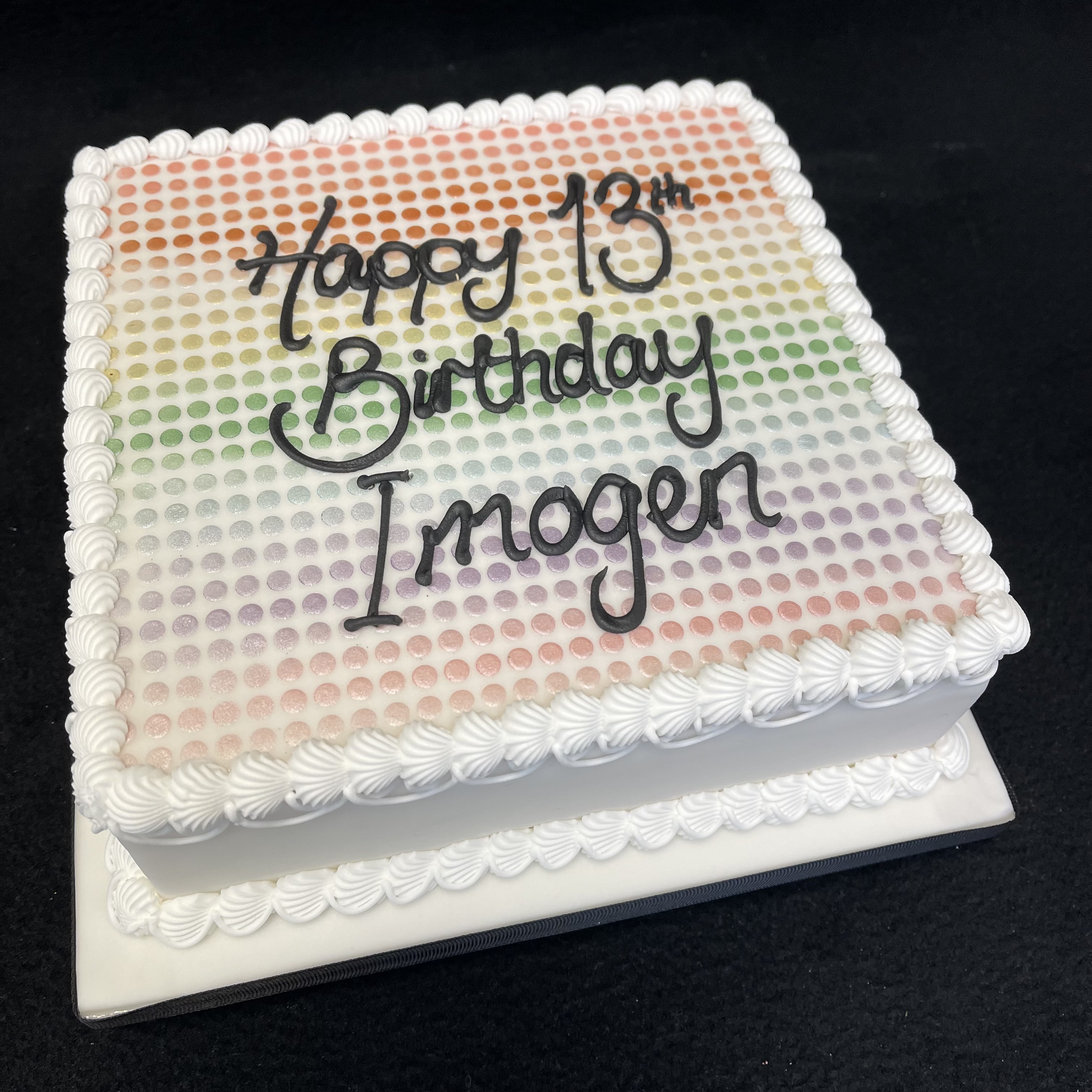 Bespoke spotty rainbow cake with vibrant multicolored dots, perfect for celebration in Solihull, West Midlands.