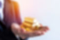 business female hand offering gold bar stack.jpg