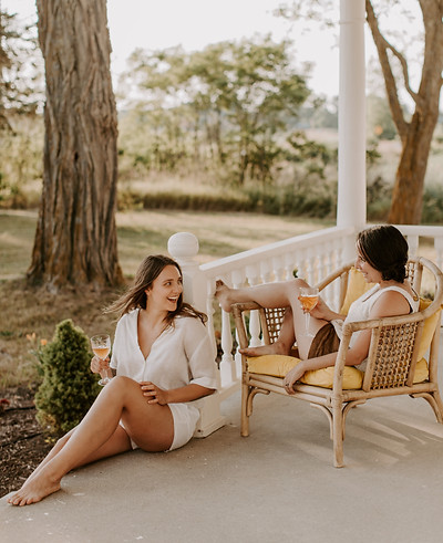 Two women chatting on a porch about how to reach their ideal audience.