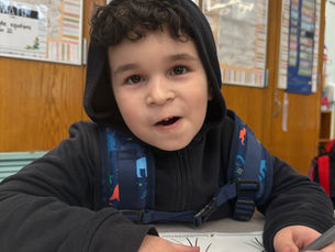 Joseph draws a picture at his desk at COMPASS P.S. 56 afterschool program
