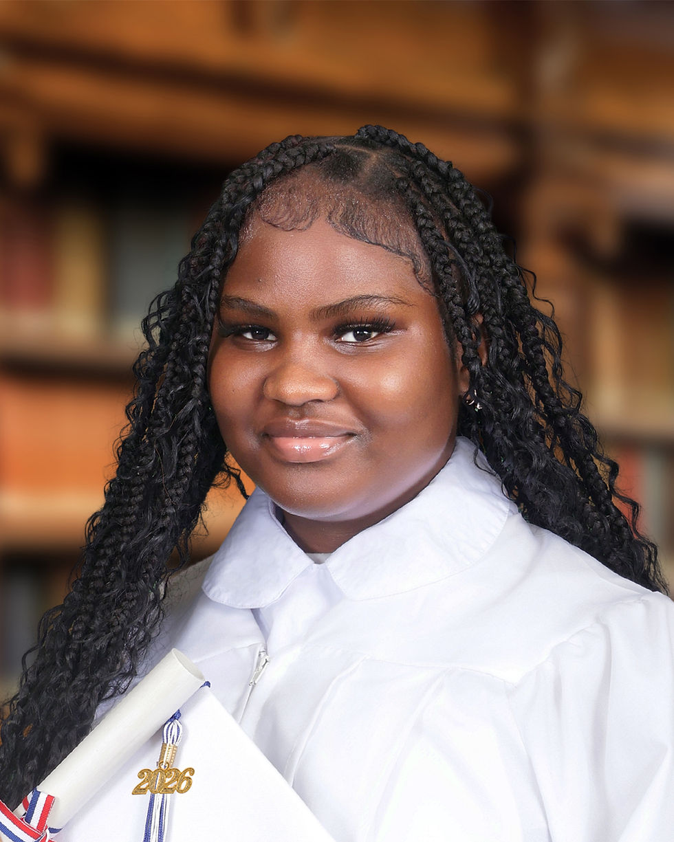 A formal portrait of an NYC community school student holding her graduation cap.