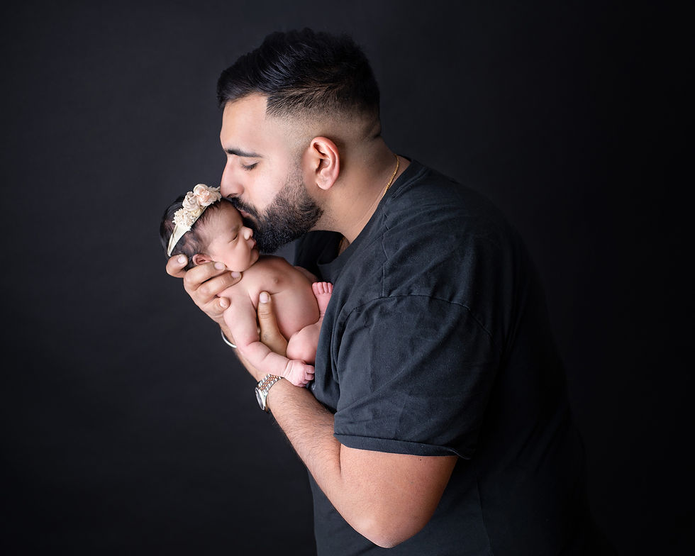 dad posing with newborn baby