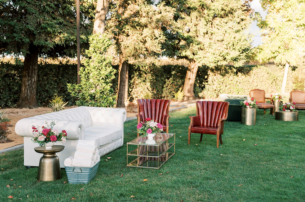 Thumbnail: Boho outdoor lounge with white sofa and red chairs