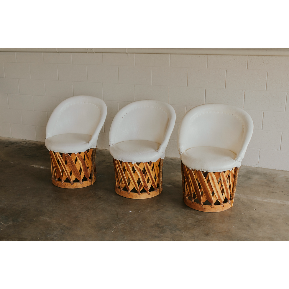 Thumbnail: Three chairs with white cushions and woven wooden bases