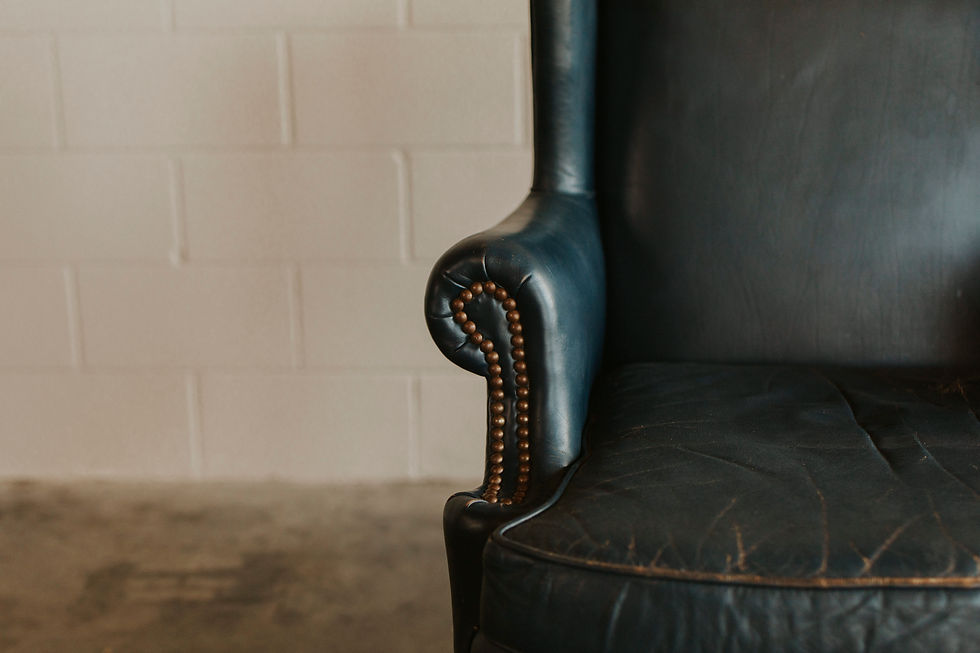 Thumbnail: Dark leather armchair with brass stud trim