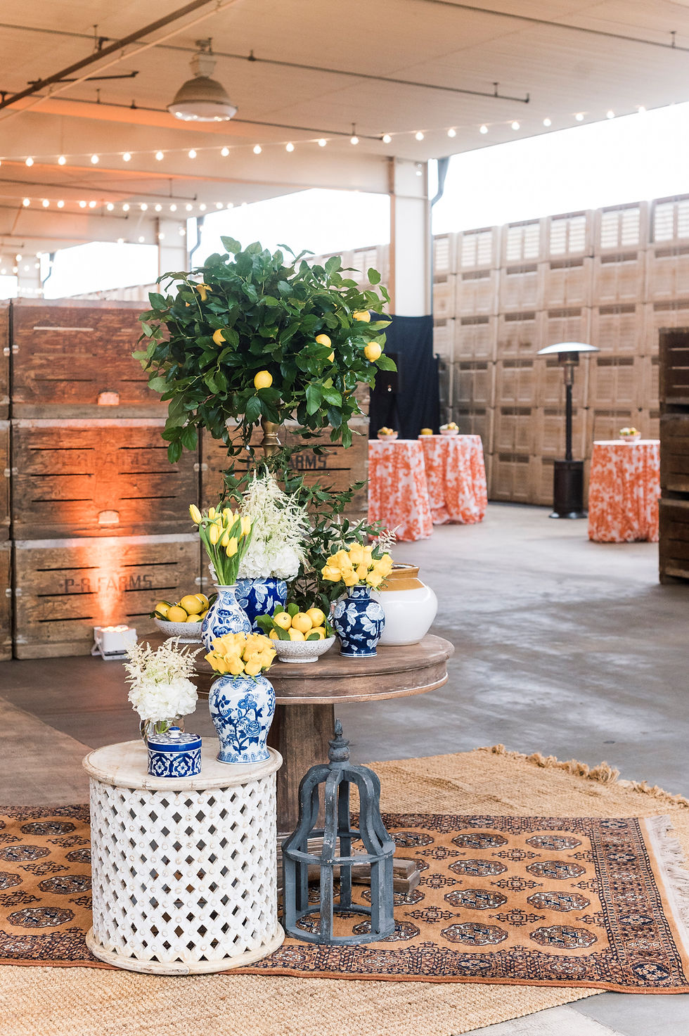 Thumbnail: Event decor with a lemon tree and blue & white floral arrangements.