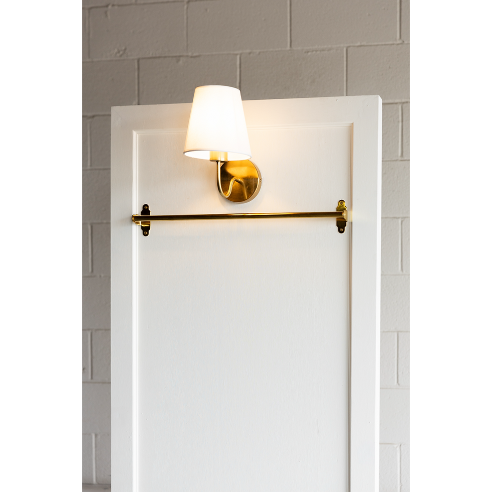 Thumbnail: White door with brass light fixture and towel bar