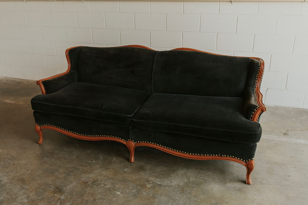 Vintage dark sofa with carved wooden legs and trim