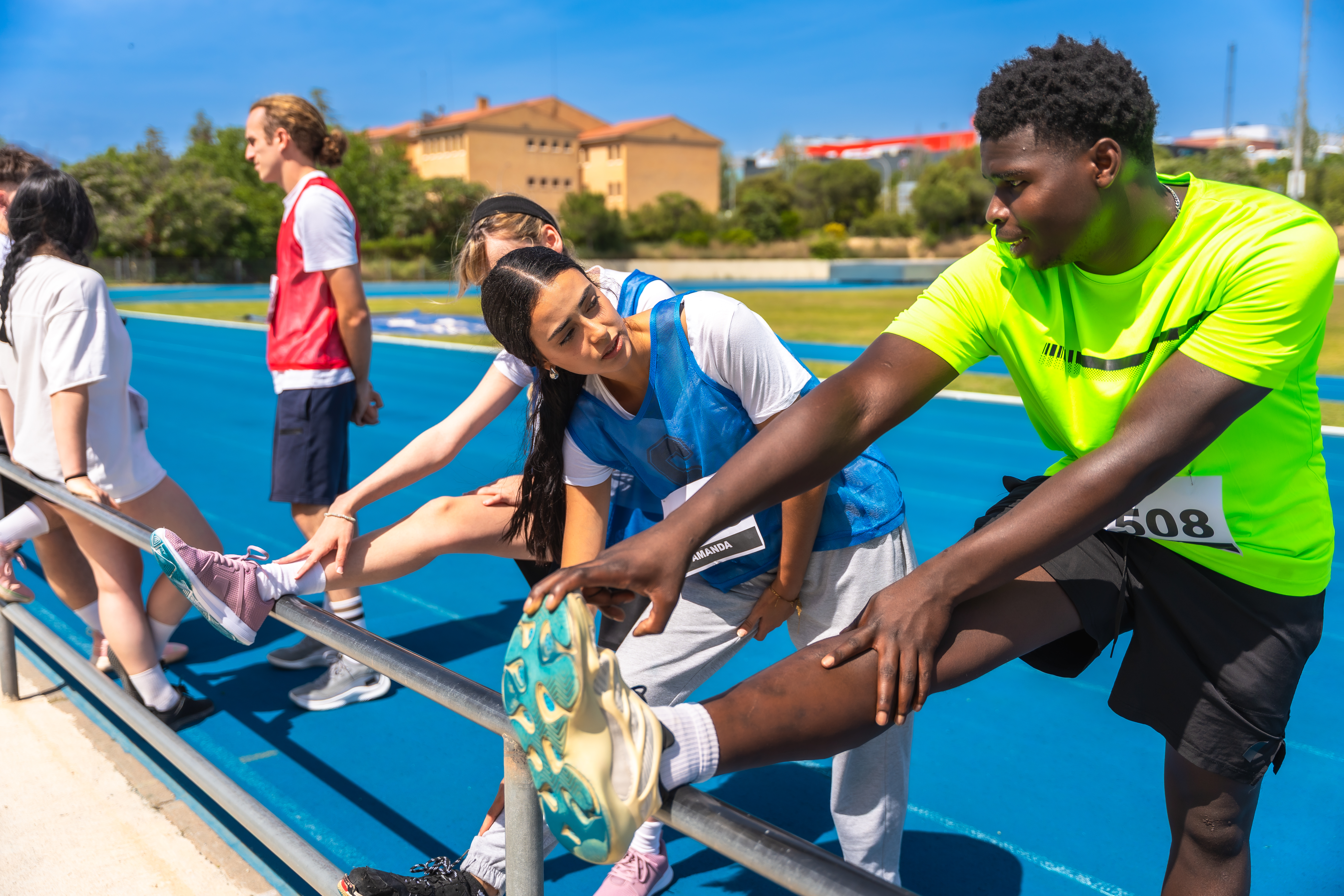athletes-stretching-legs-on-track-and-field-prepa-2025-11-11-18-21-27-utc.jpg