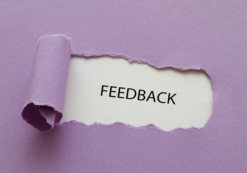 a purple sheet of paper with a section peeled back to display the word "feedback"