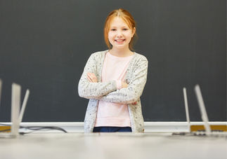 young woman with crossed arms smiling
