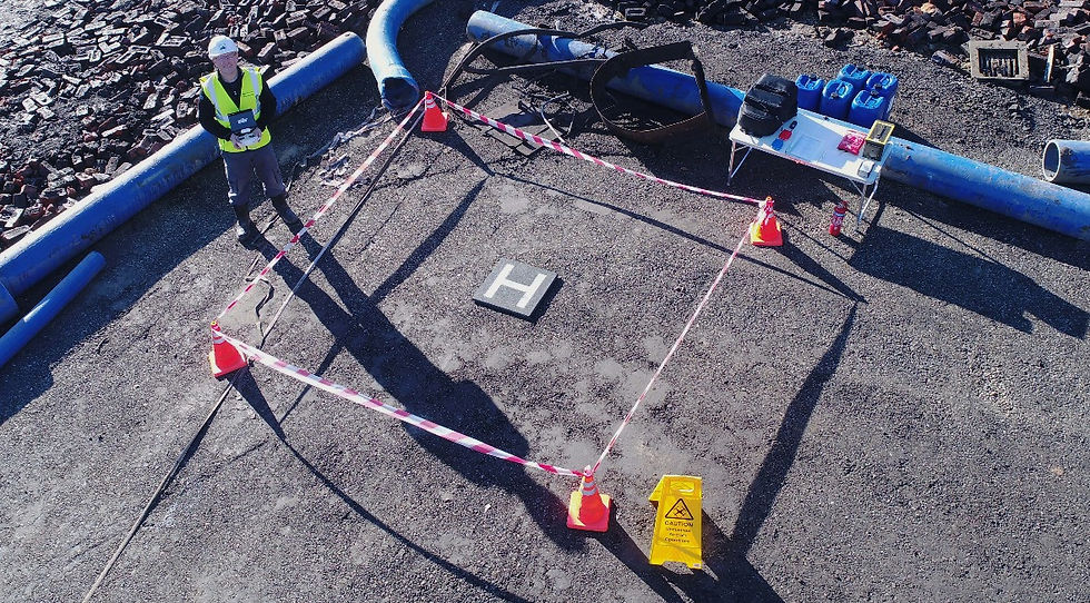 Drone selfie of remote pilot on a demolition site showing setup of take-off and landing zone