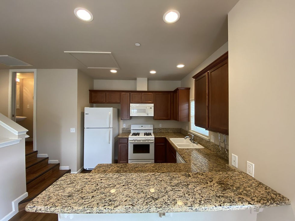 Modern kitchen with updated appliances and generous granite counter space