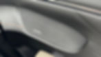 Close-up of a car speaker with a gray mesh design and "DEEPAL" text in white. The speaker is set in black leather with orange stitching.