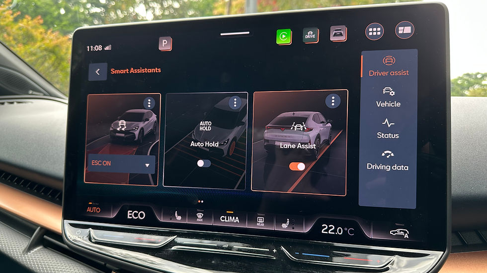Car dashboard screen showing smart assistant options: ESC, Auto Hold, Lane Assist. Background trees visible through the window. Temperature: 22°C.