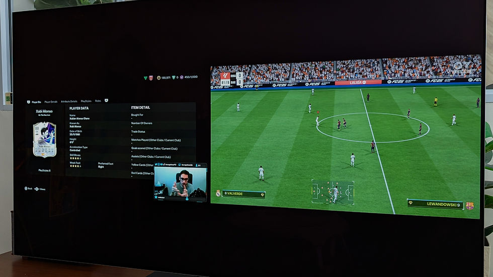 Split-screen TV image: Xabi Alonso player data on left, FC25 soccer match on right. Inception streaming in small window. Vibrant green pitch.