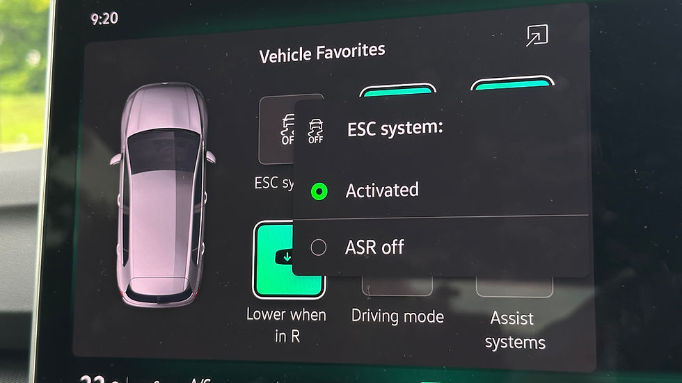 Car dashboard screen showing ESC system activated. Options like "Lower when in R" and "Driving mode" visible. Time displayed as 9:20.