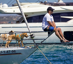 Man, dog, and boat.