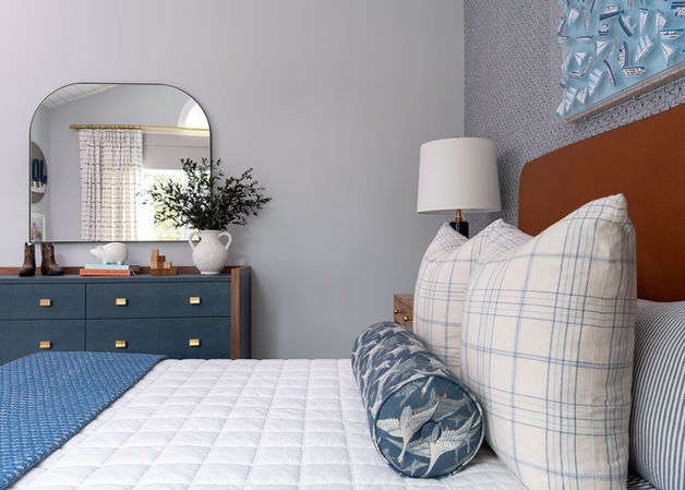 Nautical little boy's bedroom design with blue accents and a custom bolster pillow.