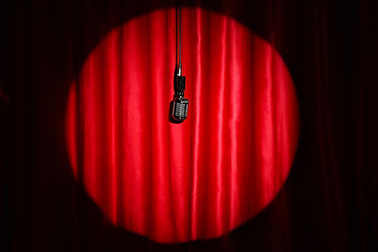 Microphone hanging near red curtain.jpg
