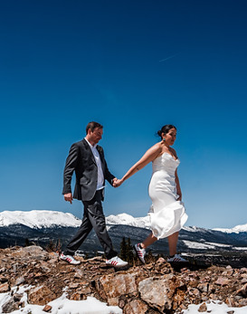 Mountain couple hikes in formal attire during their Breckenridge reception