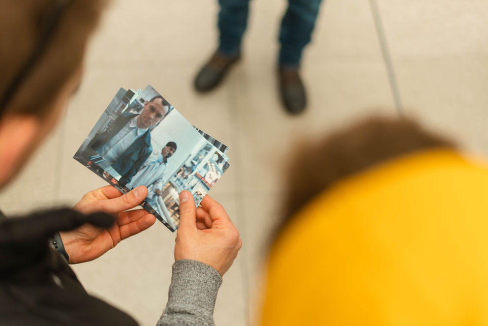 Person holding photos, viewing images from a Hollywood film, Storyboard Experiences